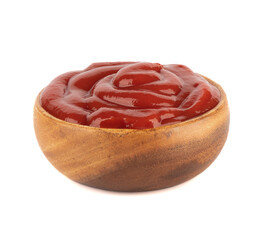 Tomato ketchup sauce in a wooden bowl on a white background.