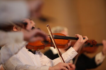 Violinist playing a musical instrument background image of a violin in an orchestra