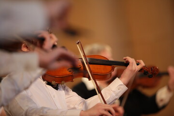 Violinist playing a musical instrument background image of a violin in an orchestra