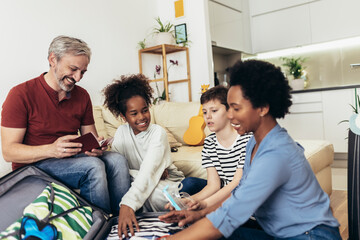 Happy family having great time and packing for summer holidays
