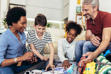 Happy family having great time and packing for summer holidays