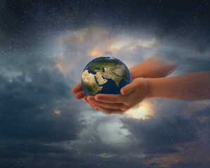 earth globe in hands on front blue starry sky nebula hold  world peace concept nature background
