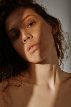 Portrait of young girl with red hair having natural beauty posing at camera with no-makeup