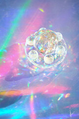 quartz crystal balls on holographic background. ball Refracting vivid rainbow colors light. Magic...