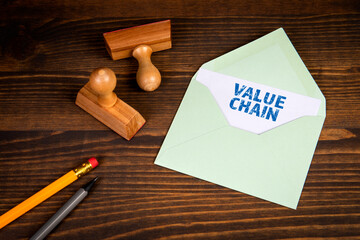 Value Chain. Letter and office supplies on a wooden background