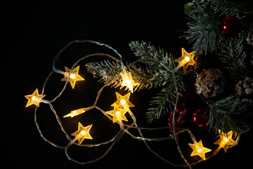 Christmas background with lights and a Christmas tree branch. Christmas lights from a garland on a...