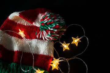 Christmas background with a Christmas hat and colorful garlands.