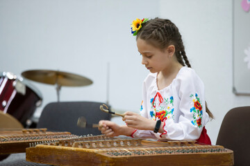 The girl plays the ethnic instrument dulcimer