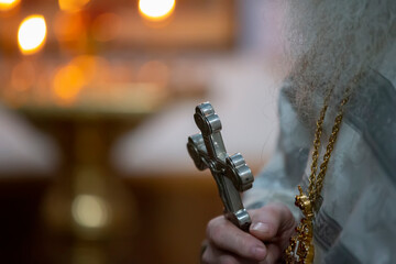 The hands of a priest with a cross. Faith and religion.
