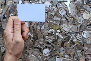 locksmith holds a spare white key card over to the customer after the customer wishes to bring the...