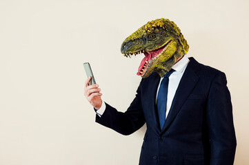 Euphoric man with lizard head with smart phone.