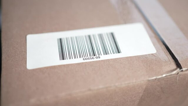 Applying a Bar Code Label on a Cardboard Box Closeup
