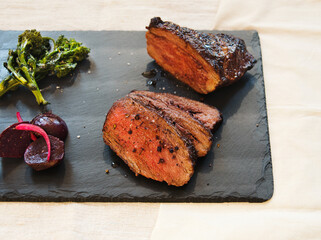 sliced tri-tip steak with beets and broccoli rabe