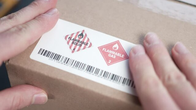 Applying a Flammable Warning Danger Label on a Shipping Box