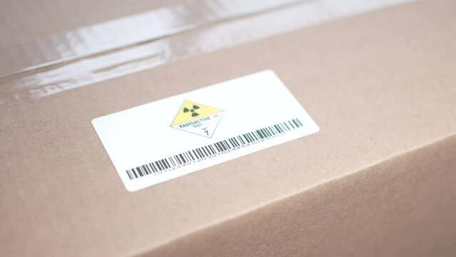 Applying a Radioactive Warning Danger Label on a Shipping Box
