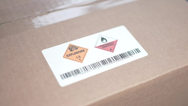 Applying an Explosive Warning Danger Label on a Shipping Box