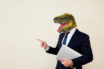 Euphoric man with lizard head with laptop