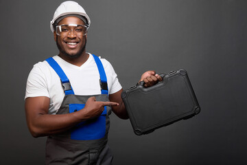 Strong black male auto mechanic by profession advertises professional tools in convenient box....