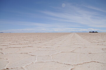Fototapeta na wymiar Car tracks on salt flat of Salar de Uyuni in Bolivia