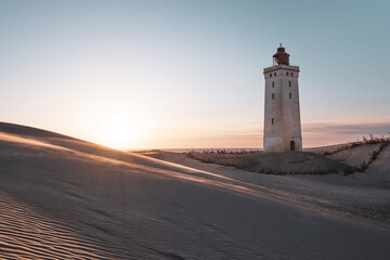 Rubjerg Knude Fyr Lighthouse in the sand dunes in northern denmark north jutland region at sunset - obrazy, fototapety, plakaty