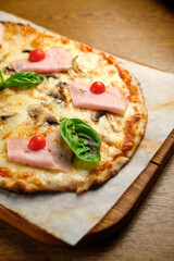Pizza with bacon and ham and tomatoes