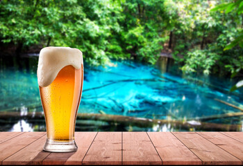 Beer glasses are placed on wooden plates amid the forest atmosphere and blue wells.