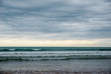 calm waves on the sea on a cloudy day