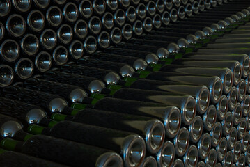 Fototapeta na wymiar Stacked wine bottles with your special wines going through the maturation process