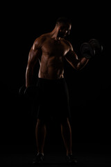 Fototapeta na wymiar Topless guy lifting weights in the gym