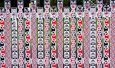 Wood fence decorated with Māori art patterns rotorua New Zealand  - obrazy, fototapety, plakaty