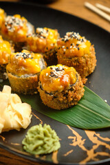 A set of sushi rolls with salmon, caviar, avocado and black sesame