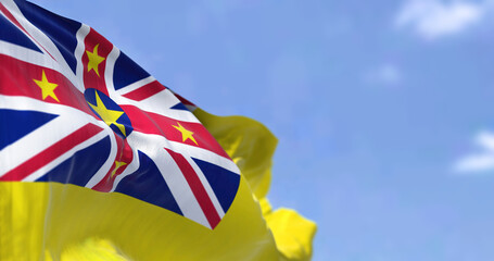 Close-up view of Niue state national flag waving in the wind