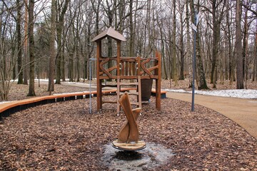 Wooden modern ecological safety children outdoor playground equipment in park. Nature architecture construction playhouse in forest. Children rest and childhood concept. Idea for games on the air. 