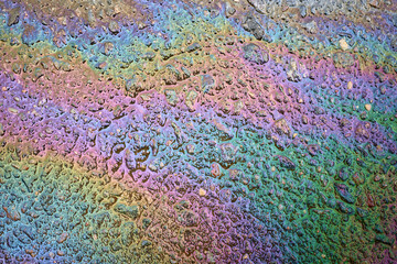 Oil slick on the asphalt road background