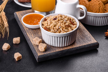 Delicious nutritious healthy breakfast with granola, eggs, oat cookies, milk and jam
