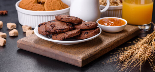 Delicious nutritious healthy breakfast with granola, eggs, oat cookies, milk and jam