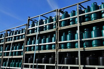 Concept of the cost of cooking and heating gas: Truck body full of liquid propane gas cylinders, abbreviated as LPG (GPL)