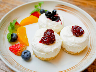 Delicious cheesecake with strawberry and blueberry sauce