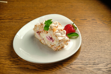 Cake with meringue roll with cream and raspberries
