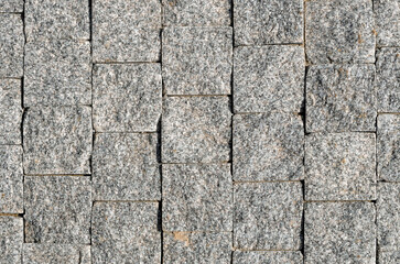 Street paved with cobblestone. paving stones, close-up.