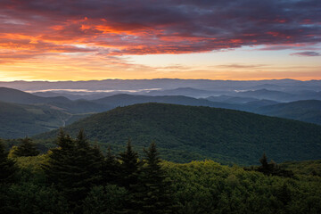 Fototapeta na wymiar A beautiful summer sunrise from along the Appalachian Trail atop Virginia's Whitetop Mountain