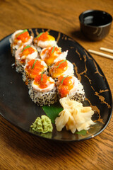 A set of sushi rolls with salmon, caviar, avocado and black sesame in close-up