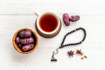Islamic rosary with dates and tea. Ramadan Kareem concept.