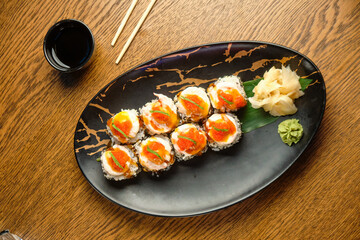 A set of sushi rolls with salmon, caviar, avocado and black sesame in close-up