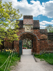 Brick gate of the entrance to Fulham House and Garden Park in London, in the spring season