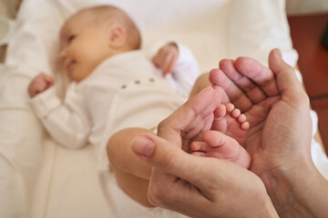 little baby feet in mother's hands