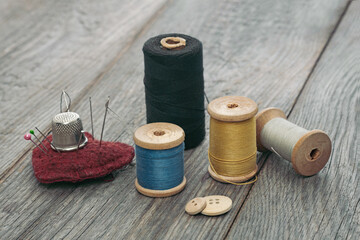 accessories for sewing and needlework on a wooden background, tailor and atelier for tailoring and repairing clothes concept