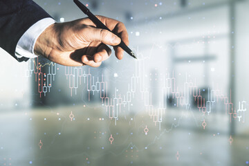 Multi exposure of trader hand with pen working with virtual abstract financial graph interface on...