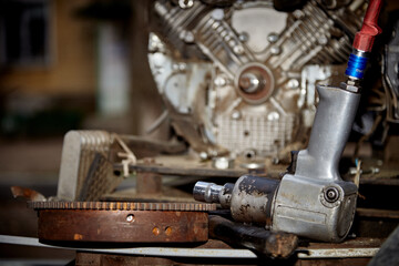 A professional mechanic works on a car engine in a garage. Car service.