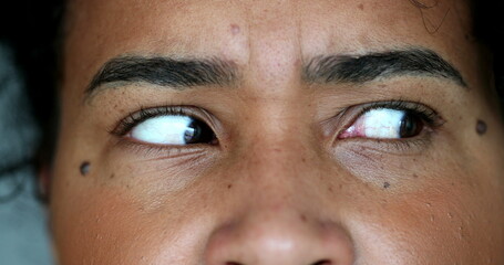 Anxious black woman macro close-up eyes looking side to side